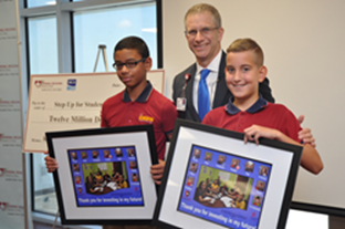 Andrew Caro, l, Richard Gil, r, fifth-graders at Kingdom Academy, thanked Kendall Regional Medical Center CEO Scott Cihak after he presented HCA's check to Step Up For Students