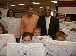 Scott A. Edmonds, President and CEO of Chico’s FAS Inc., with a group of second grade students at Evangelical Christian School in Fort Myers