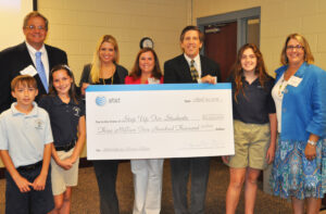 Marshall Criser III, President of AT&T Florida, joins Attorney General Pam Bondi, OLL parent Carrie Hart, Step Up For Students President Doug Tuthill, scholarship recipients and Kathy Bogataj, Principal at Our Lady of Lourdes Catholic School for the cyber safety event. Scholarship recipients pictured are Jacob Whiteley, Mikayla Whiteley, and Christina Chandler.