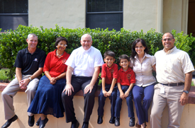 John Ufheil of Daytona Beverages, LLC joins Basilica School of St. Paul Principal Betty Powers, Father Tim Daly, scholarship students Enrico Paredes and Felipe Paredes, and their parents Maria Gomez de la Torre and Cesar Paredes, at the school.  
