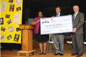  April Kelly-Drummond joins Step Up For Students President Doug Tuthill and Florida College Academy Principal Lynn Wade (right) to present Denny’s contribution to Step Up For Students.