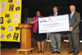 April Kelly-Drummond joins Step Up For Students President Doug Tuthill and Florida College Academy Principal Lynn Wade (right) to present Denny’s contribution to Step Up For Students.