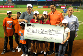 Step Up For Students receives $4.5 million from Waste Management for scholarship funds in 2013 during pre-game Miami Marlins festivities on Friday, Sept. 6. From left: Grace Academy International Central in Opa-Locka students David, Esther and Joseph Estime; Step Up for Students President Doug Tuthill; Champagnat Catholic School in Hialeah students Maria and Dayanna Garcia; Florida State Rep. Manny Diaz Jr.; Waste Management Government Affairs Manager Alex Gonzalez and his granddaughter Samantha Masood.