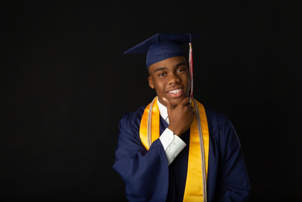 Senior photo headshot of african american male wearing cap and gown